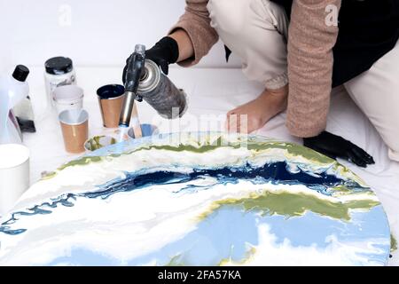 The process of creating a painting using fluid art technique. Stock Photo