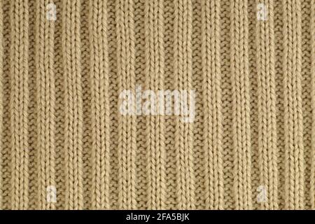 Knitwear. Close-up of a fragment of a knit with a characteristic yarn weave. Stock Photo