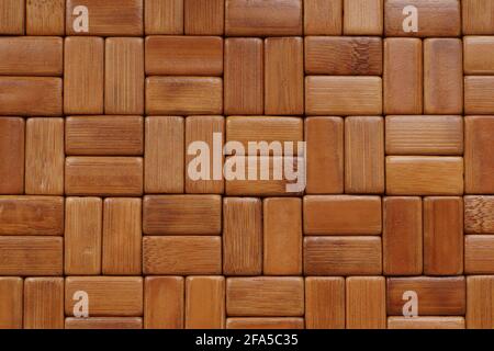 The mat is made of rectangular, sanded and varnished bamboo wood blocks. Background. Stock Photo
