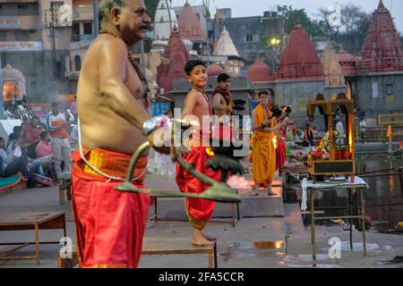 Ujjain, India - March 2021: Priests performing Evening Aarti on the Ujjain ghats on March 24, 2021 in Madhya Pradesh, India. Stock Photo