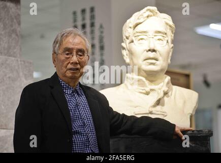 (210423) -- CHENGDU, April 23, 2021 (Xinhua) -- Yang Wuneng poses for a photo at an exhibition area dedicated to his translation achievements at Chongqing Library in southwest China's Chongqing Municipality, April 18, 2021.  In a career that spans over 60 years, Yang Wuneng has translated 31 German classics into the Chinese language, including 'Faust', 'Selected Poems of Heinrich Heine' and 'Immensee.' Many of his translations are still bestselling books in some bookstores. His translation of 'Grimms' Fairy Tales,' for instance, has been popular among Chinese readers for many generations. Toda Stock Photo