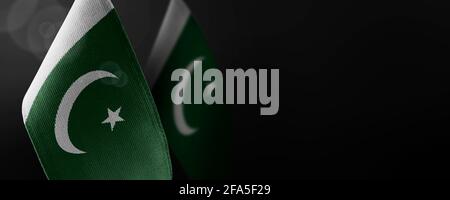 Small national flags of the Pakistan on a dark background Stock Photo