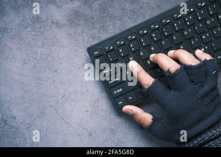 hacker hand stealing data from computer top down  Stock Photo