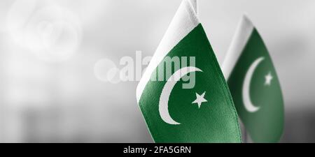 Small national flags of the Pakistan on a light blurry background Stock Photo