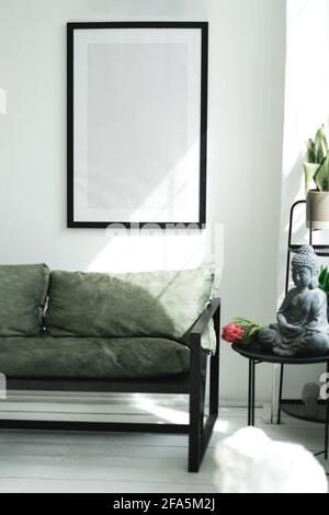 A mockup with a large black frame on the wall. Stock Photo
