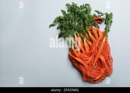 String bag with carrot on light gray background Stock Photo