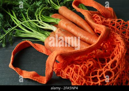 String bag with carrot on dark wooden background Stock Photo