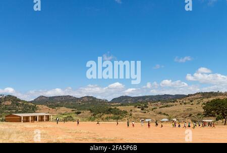 Children playing football near a school in Mzimba district, Malawi Stock Photo