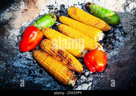 Cooked vegetables on the fire . Corns, peppers and zucchini . picnic with healthy eating Stock Photo