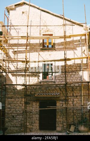 Low rise modern building surrounded by scaffolding Stock Photo