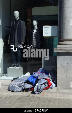 Homeless persons sleeping bag in shop window Stock Photo