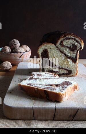 Homemade traditional Romanian sweet bread named "cozonac", with cacao, raisins, and nuts. Eastern European baked dessert. Babka. Stock Photo