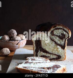 Homemade traditional Romanian sweet bread named "cozonac", with cacao, raisins, and nuts. Eastern European baked dessert. Babka. Stock Photo