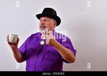 Elderly American gentleman planning while drinking coffee Stock Photo