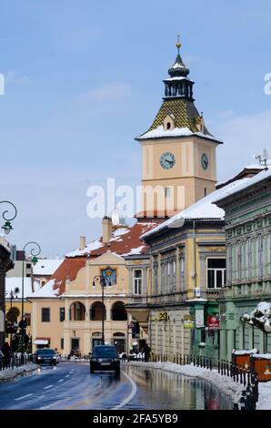 Spring snow in the Historic Centre of Brasov Romania. The famous Casa Sfatului - known in English as The Council House - is prominent in the backgroun Stock Photo