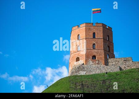 Gediminas Tower or Castle, the remaining part of the Upper Medieval Castle in Vilnius, Lithuania with Lithuanian flag on the top in a sunny day Stock Photo
