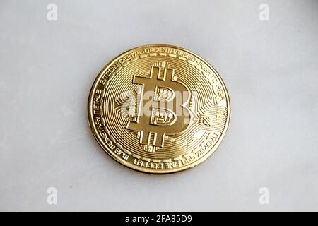 Golden bitcoin coin isolated on white background. The popular cryptocurrency is bitcoin. Stock Photo