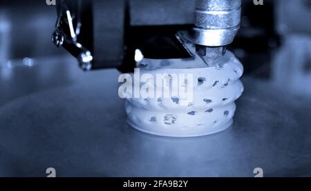 3d printer printing objects blue gray color form closeup. Stock Photo