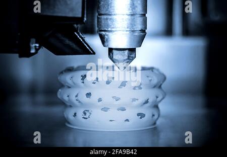 3d printer printing objects blue gray color form closeup. Stock Photo