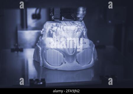 3D printer prints the form of molten plastic white. Stock Photo