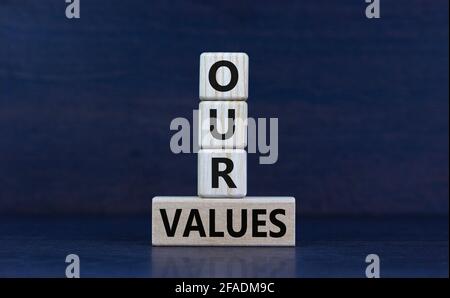 Our values symbol. Wooden cubes and block with words 'our values' on beautiful grey background. Business and our values concept, copy space. Stock Photo