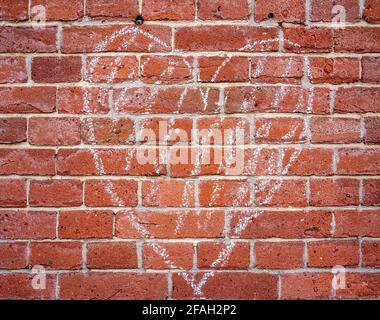 Background of a chalk drawn heart on a brick wall Stock Photo