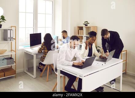 Group of multiethnic business colleagues working together in open space coworking. Stock Photo