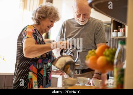 Senior couple together in their kitchen at home Stock Photo