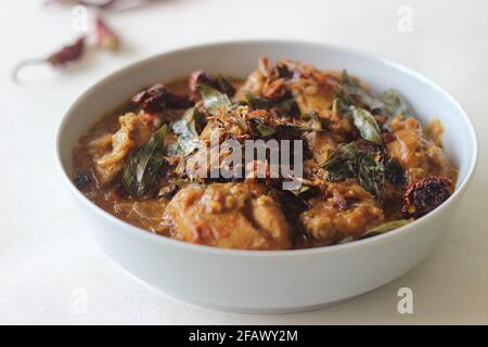 Kerala style chicken curry made with home ground masala. Shot on white background Stock Photo