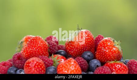 Pile Od Strawberries, Blueberries, Raspberries In A Pile On Green 