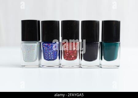 Collection of multi-colored bottles of nail polish. Layout for design on a gray background. Stock Photo