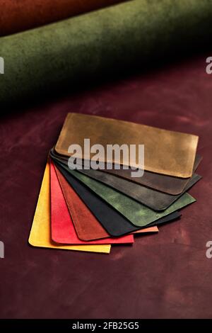 Artificial leather samples on a cow leather background. Top view Stock Photo