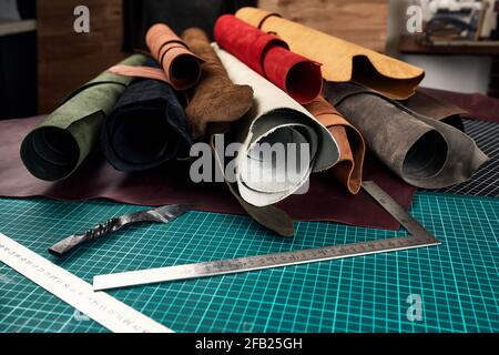 Artificial leather samples on a cow leather background. Top view Stock Photo