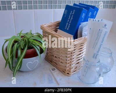 NHS COVID-19 Coronavirus lateral flow antigen testing devices and swabs stored ready for use in a domestic UK family bathroom Stock Photo
