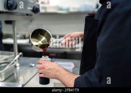chef preparing sauce for his dishes Stock Photo