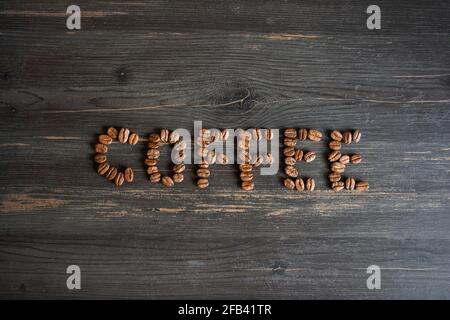 Coffee beans form a word on a black background Stock Photo