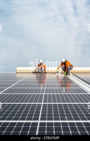 Unrecognizable solar panel technicians working a Spanish factory Stock Photo