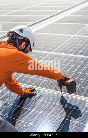 Unrecognizable solar panel technicians working in Spanish installation Stock Photo
