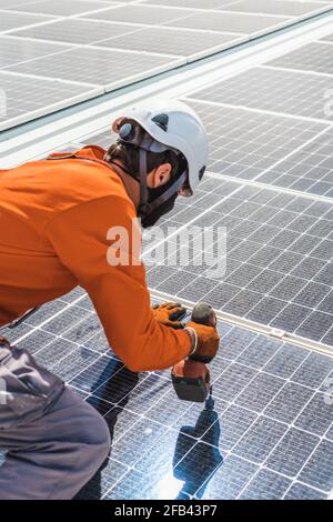 Unrecognizable solar panel technician working in Spanish installation Stock Photo