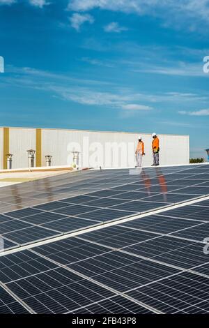 Unrecognizable solar panel technicians posing in Spanish installation Stock Photo