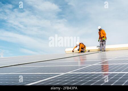 Unrecognizable solar panel technicians working in Spanish installation Stock Photo