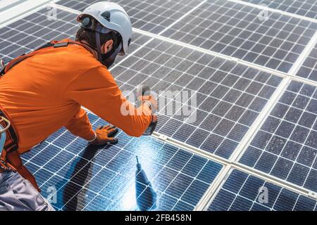 Unrecognizable solar panel technician working in Spanish installation Stock Photo