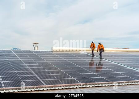 Unrecognizable solar panel technicians walking in Spanish installation Stock Photo