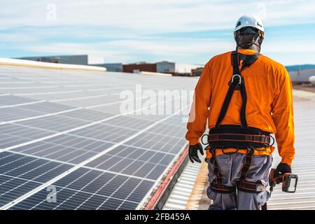 Unrecognizable solar panel technician walking in Spanish installation Stock Photo