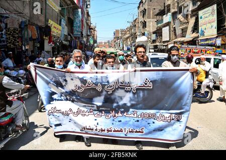 Members of Gandhara Hindko Board participate in rally to pay tribute to the score of people, who were killed 78 years ago by the firing of British Troops in Qissa Khawani Bazar Tragedy on 23rd April 1930, at Qissa Khawani Bazar in Peshawar on Friday, April 23, 2021. Stock Photo