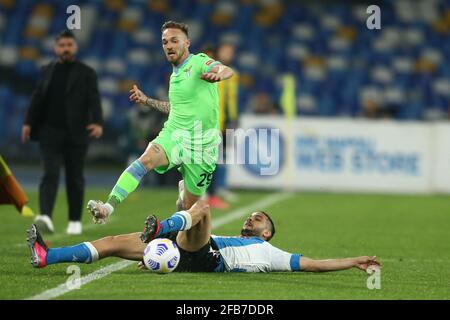 LazioÕs Italian midlefer Manuel Lazzari challenges for the ball with SSC Napoli's Greek defender  Konstantinos Manolas  during the Serie A football match between SSC Napoli and SS Lazio at the Diego Armando Maradona Stadium. Napoli won 5-2. Stock Photo