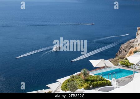 Perfect view of Santorini: swimming pool in luxury hotel and yachts Stock Photo