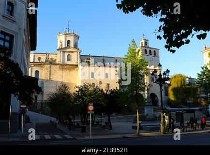 Santander Cathedral from the Paseo de Pereda in the city centre of Santander Cantabria Spain with a statue of the Virgin Mary in front Morning sun Stock Photo