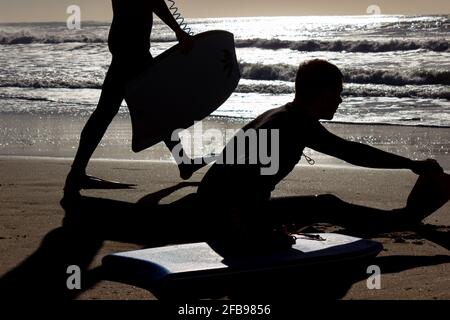 Man preparing to surf on a sunny day. Stock Photo