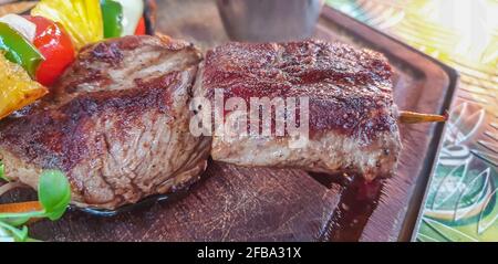 Namibian braai, Kudu, Springbok, Zebra steak with salad at a Restaurant in Windhoek, close up with selected focus Stock Photo
